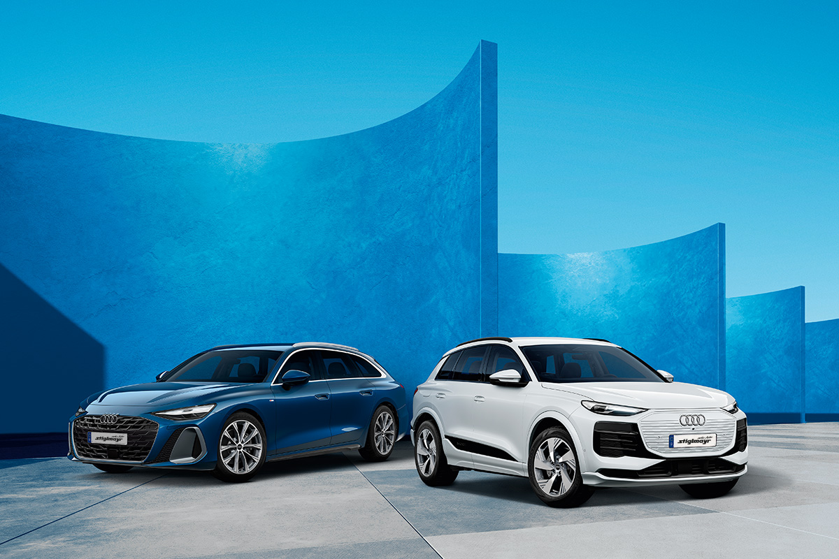 zwei Audi Modelle vor futuristischem Hintergrund